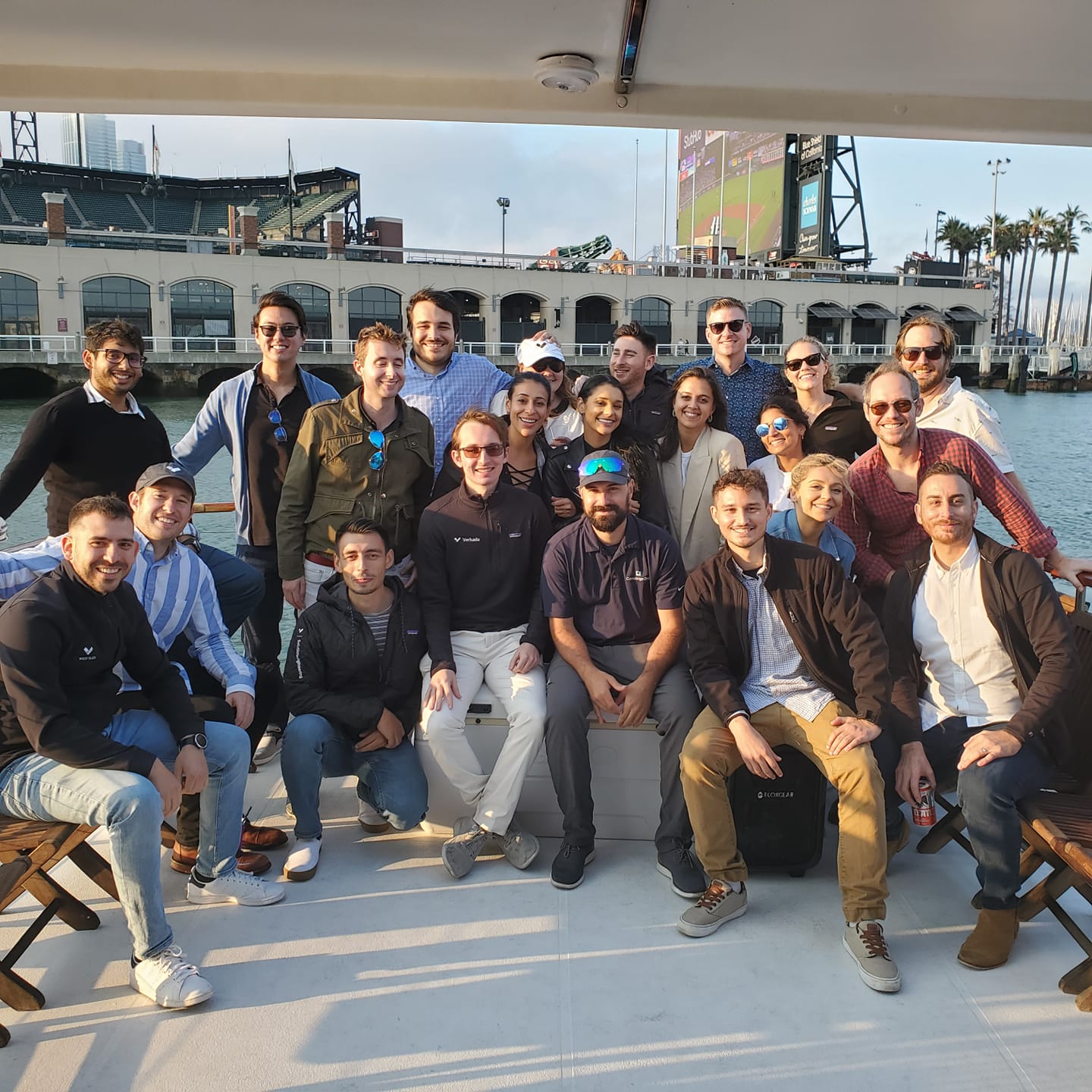 Corporate group with Oracle Park behind