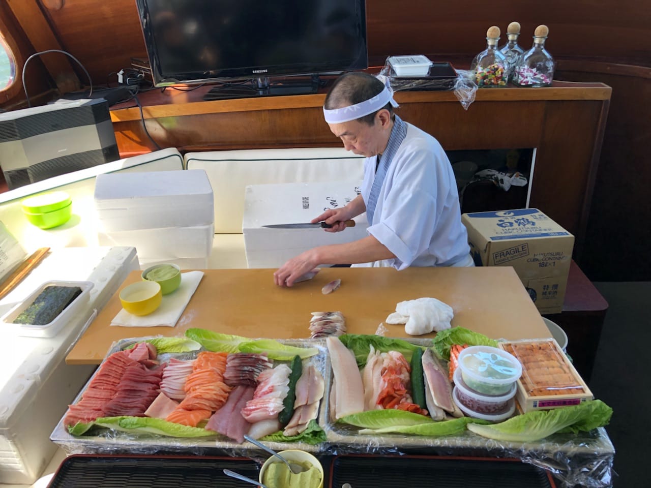 Sushi chef with knife, wooden interior