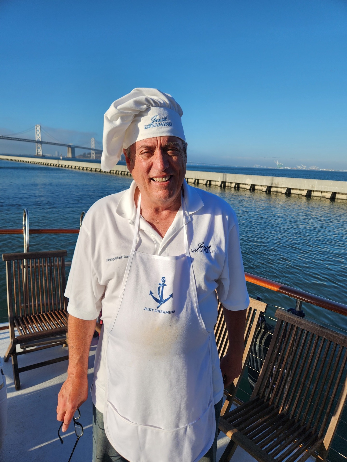 Captain Larry Murray aboard Just Dreaming with the Bay Bridge behind